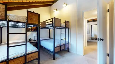 two bunk beds in a room with a hallway at La Vista Blanc #16 condo in Mammoth Lakes