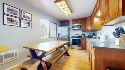 a kitchen with a wooden table and a counter top at La Vista Blanc #16 condo in Mammoth Lakes