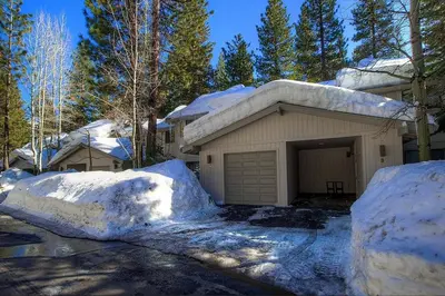 a house with a garage and snow piled up at Ski Lake Lodge home in Incline Village