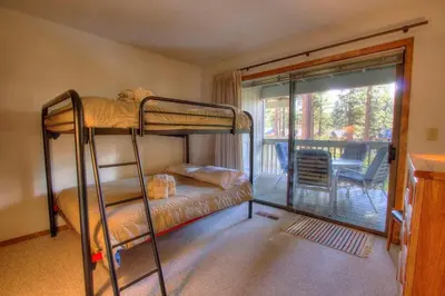a bedroom with two bunk beds and a balcony at Ski Lake Lodge home in Incline Village