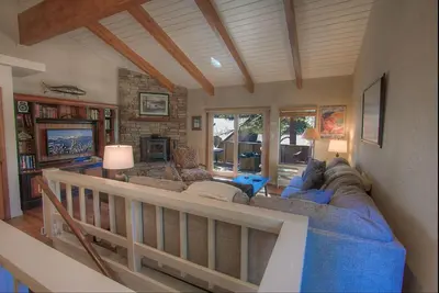 a living room with a blue couch and a fireplace at Cozy Bear Lodge home in Incline Village