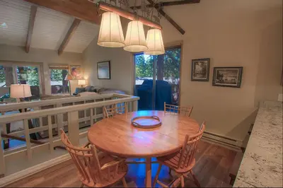 a dining room with a wooden table and chairs at Cozy Bear Lodge home in Incline Village
