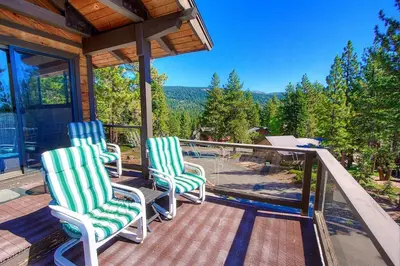three chairs on a porch with a view of the mountains at Inclining View home in Incline Village