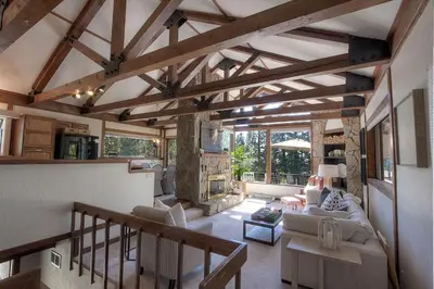 a living room with wooden ceilings and a living room with a fireplace at Inclining View home in Incline Village