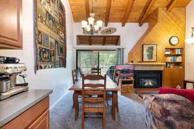 a kitchen and dining room with a table and a fireplace at 2BR Townhome Walk to Beach or Trails in Carnelian Bay