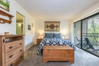 a bedroom with a bed and a balcony at 2BR Townhome Walk to Beach or Trails in Carnelian Bay