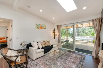 a living room with a couch and a glass table at Modern Meadow Vista Vacation Home with Spacious Deck in Meadow Vista