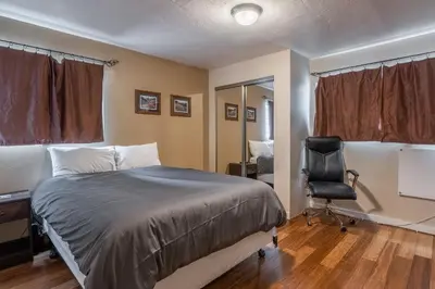 a bedroom with a bed and a desk and a chair at Tyrolean Village 6 2 Bedroom 1 and a Half Bath Sleeps 6 Walk to Lift Steps to town shuttle in Mammoth Lakes