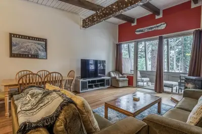 a living room with a couch and a table at Tyrolean Village 6 2 Bedroom 1 and a Half Bath Sleeps 6 Walk to Lift Steps to town shuttle in Mammoth Lakes