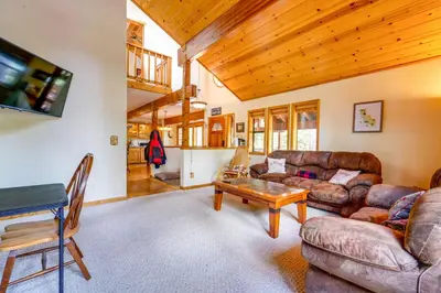 a living room with a couch and a table at Deck with Hot Tub Serene Cabin in Truckee in Truckee