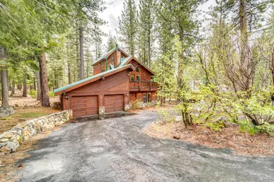 a cabin in the woods with a driveway at Deck with Hot Tub Serene Cabin in Truckee in Truckee