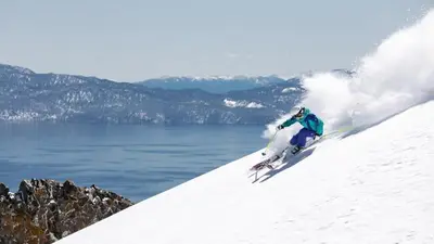 a person is skiing down a snow covered slope at Bright 3BDR Near Beach and Slopes in Kings Beach