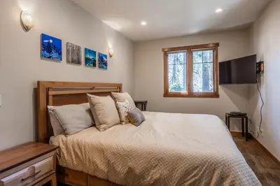 a bedroom with a bed and a tv on the wall at Grayfox #4 3 Bedroom 3 Bathroom Sleeps 8 Walk to Village Gondola in Mammoth Lakes