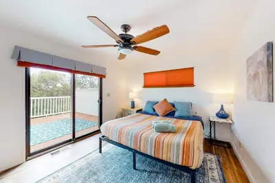 a bedroom with a bed and a ceiling fan at Cozy and Comfortable Yosemite Portal in Oakhurst