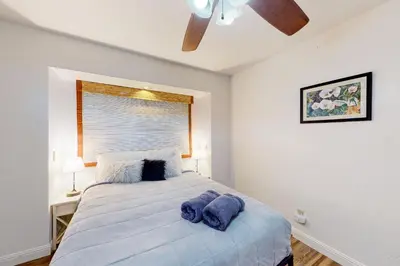 a bedroom with a bed with blue towels on it at Cozy and Comfortable Yosemite Portal in Oakhurst