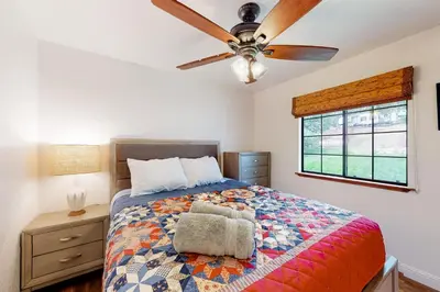 a bedroom with a bed and a ceiling fan at Cozy and Comfortable Yosemite Portal in Oakhurst