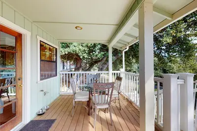 a porch with a table and chairs on it at Cozy and Comfortable Yosemite Portal in Oakhurst
