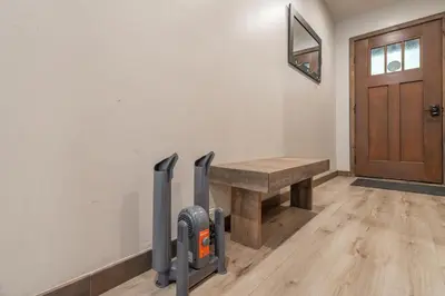 a room with a wooden table and a wooden door at Northstar Resort True Ski In Ski Out Year-Round Hot Tubs Book on Your Mobile for Promo Price in Truckee