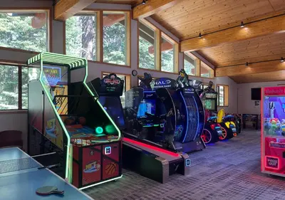 a room with several arcade games in it at Northstar Resort True Ski In Ski Out Year-Round Hot Tubs Book on Your Mobile for Promo Price in Truckee