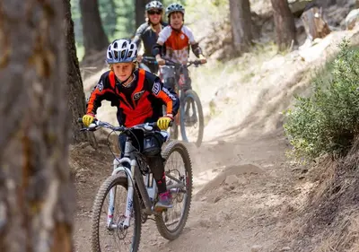 a group of people riding bikes on a dirt trail at Northstar Resort True Ski In Ski Out Year-Round Hot Tubs Book on Your Mobile for Promo Price in Truckee