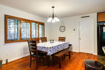 a dining room with a table and chairs at Cozy Mi-Wuk Village Cabin with Deck! in Mi-Wuk Village