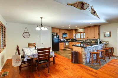 a kitchen with a table and some chairs in a room at Cozy Mi-Wuk Village Cabin with Deck! in Mi-Wuk Village