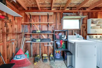 a kitchen with a stove and a washing machine at Fire Pit, Deck and Grill Cozy Twain Harte Cabin! in Twain Harte