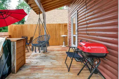 a patio with a swing and a grill on a deck at Fire Pit, Deck and Grill Cozy Twain Harte Cabin! in Twain Harte