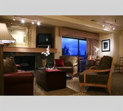 a living room with couches and a fireplace and a table at GetAways at the Lodge at Kingsbury Crossing in Stateline