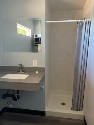 a bathroom with a shower and a sink at Travel Inn Gilroy in Gilroy