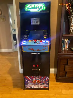 a video game arcade machine in a room at Sequoia Basecamp with Hot Tub Oasis in Visalia
