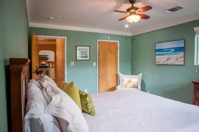 a person laying on a bed in a bedroom at Sequoia Basecamp with Hot Tub Oasis in Visalia