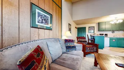 a living room with a couch and a table at Summit #232 condo in Mammoth Lakes