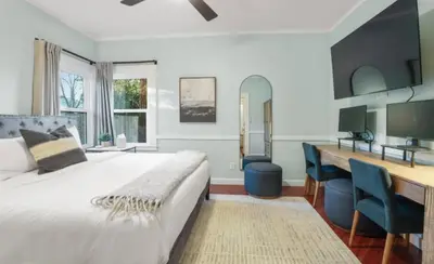 a bedroom with a bed and a desk with a computer at Grape Escape Inn & Suites in Lodi