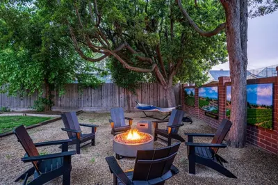 a group of chairs and a fire pit in a yard at Grape Escape Inn & Suites in Lodi