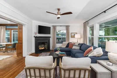 a living room with a blue couch and a fireplace at Grape Escape Inn & Suites in Lodi