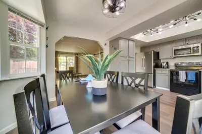 a dining room and kitchen with a table and chairs at Centrally Located Reno Retreat with Patio and Yard in Reno