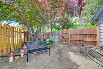 a blue bench in a yard next to a fence at Centrally Located Reno Retreat with Patio and Yard in Reno