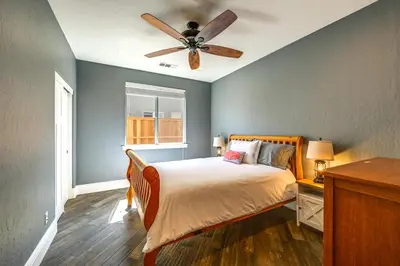 a bedroom with a bed and a ceiling fan at California Vacation Rental with Private Pool and Patio in Visalia