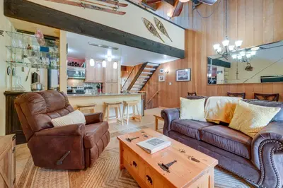 a living room with two couches and a table at Cozy Kings Beach Condo Near Lake Tahoe and Skiing in Kings Beach