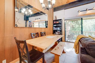 a dining room with a wooden table and chairs at Cozy Kings Beach Condo Near Lake Tahoe and Skiing in Kings Beach