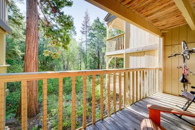 a porch of a cabin with a view of the woods at Cozy Kings Beach Condo Near Lake Tahoe and Skiing in Kings Beach