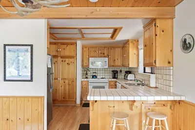 a kitchen with wooden cabinets and a counter top at Cozy 3BDR - 1 Minute to the Beach! in Tahoe Vista