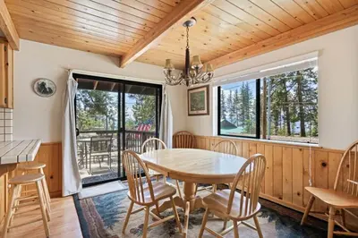 a dining room with a wooden table and chairs at Cozy 3BDR - 1 Minute to the Beach! in Tahoe Vista