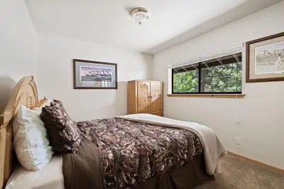 a bedroom with a bed and a window at Cozy 3BDR - 1 Minute to the Beach! in Tahoe Vista