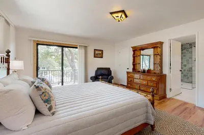 a bedroom with a large bed with a dresser and a window at Walling Mountain Retreat in Groveland