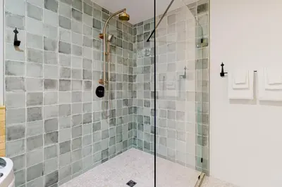 a shower with a glass door in a bathroom at Walling Mountain Retreat in Groveland