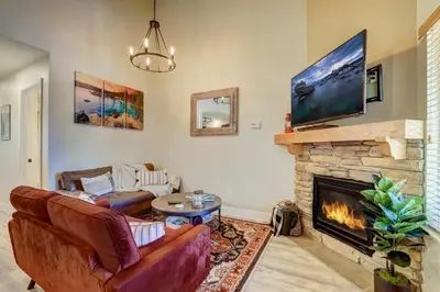 a living room with a couch and a fireplace at Private condo steps from ski lift minutes to lake in Stateline