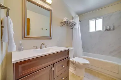 a bathroom with a sink and a toilet and a tub at Relax Fireside! Tahoe Area Home 28 Mi to Slopes in Carson City