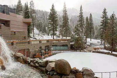 a pool of snow in front of a building with a waterfall at Resort at Everline Resort & Spa #560 in Olympic Valley